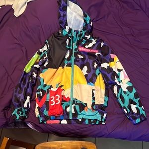 Windbreaker zip up jacket with draw string hood.